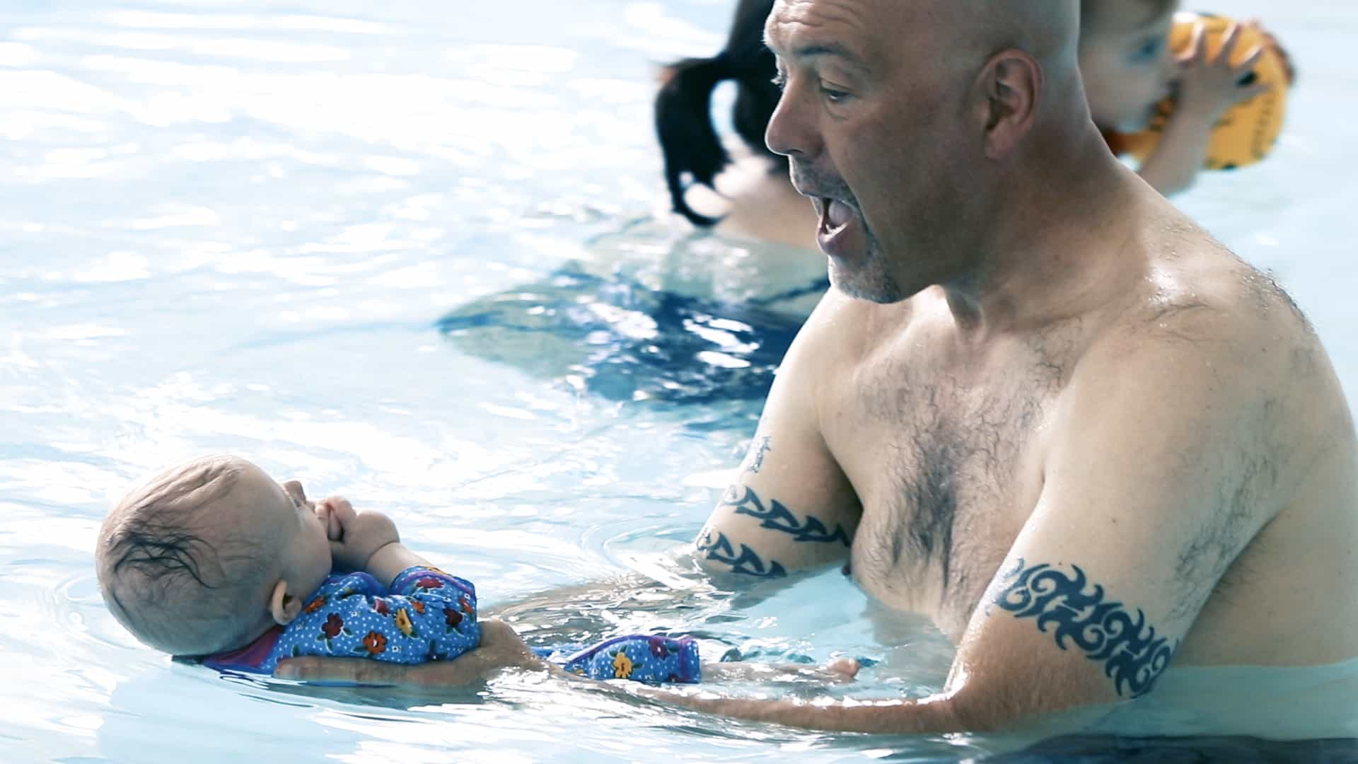 Baby and father in the pool